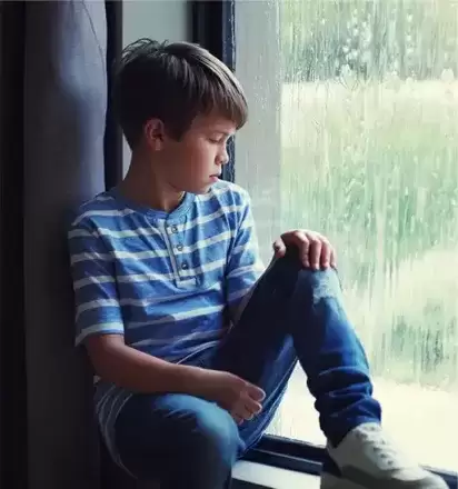 8 year old foster child looking out window sadly