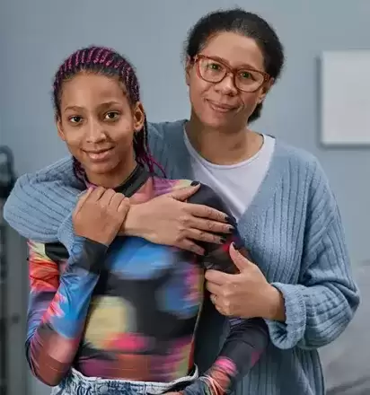 Foster mom hugging her teenage foster daughter