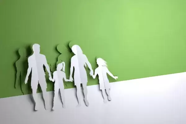 paper people cutouts of foster mom and dad with 2 foster children green background