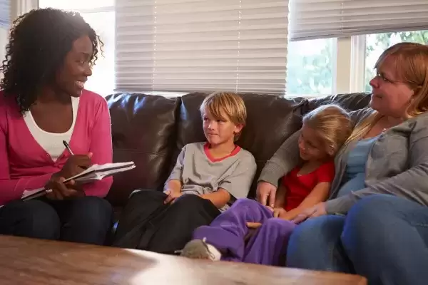 social worker interviewing foster mom and foster brother and sister