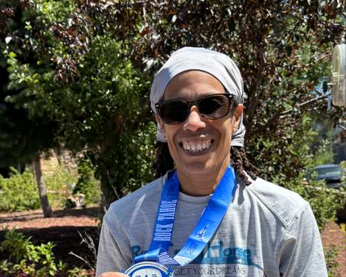 Nanette Jorge with a medal for finishing a marathon around her neck