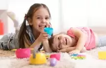Two children on the floor playing