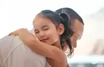 A girl foster child hugging their foster dad
