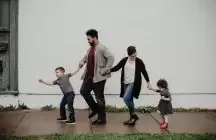 foster family with two kids on a street
