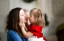A foster bay kissing a foster mother