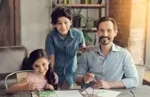 Foster dad and foster children sitting at the table 