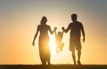 Foster family silhouette on sunset background