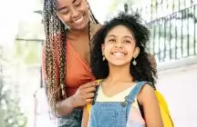 foster teen wearing yellow backpack with foster mom in park