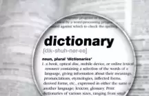 A magnifying glass over a dictionary page