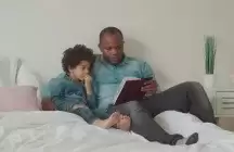 Foster Parent reading a book to a child