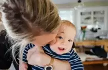 Foster parent holding a baby in her arms