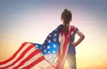 A foster child with a American flag around her shoulders