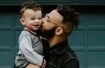 Foster Father and child in his arms kissing