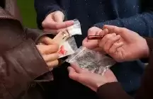 Four hands holding Common Street Drugs