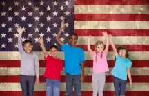 Foster children standing in front of an American flag