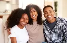 Foster siblings with foster mum in kitchen