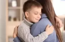 Foster child giving hug to his foster to adopt mum
