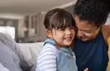 Child with foster mom in front room