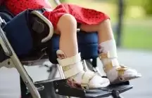 Foster child in a wheel chair only see their legs and chair red dress