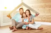 Husband and wife with a child under a toy roof