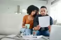 a young potential foster couple looking over their finances