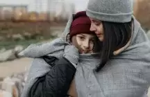 Foster mom holding a teenager child outdoors
