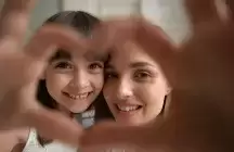foster kid and foster mom making heart with hands