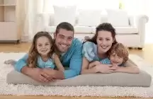 foster family with two kids on a rug