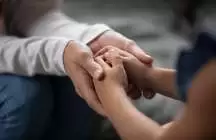 Adult holding a child's hand 
