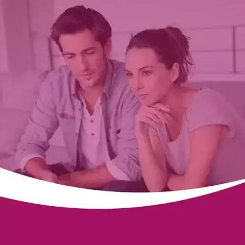 Foster parents studying a guide